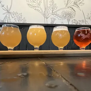 three glasses of beer on a table