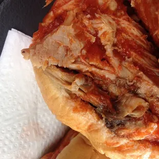 Pulled pork sandwich on white buns.