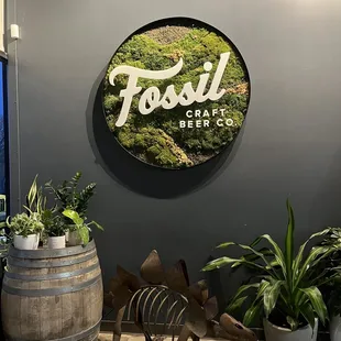 a dinosaur in front of a fossil sign