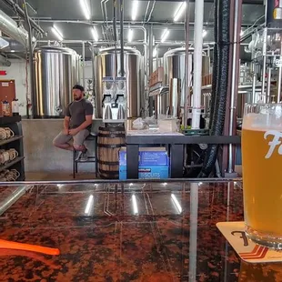a glass of beer on a bar