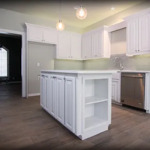 a clean kitchen with white cabinets