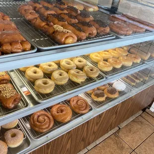 a variety of donuts in a display case