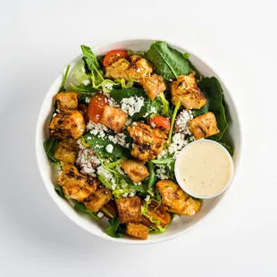 mediterranean chicken caesar: chicken kebab, tomatoes, feta, pita croutons, baby kale , romaine with tahini caesar