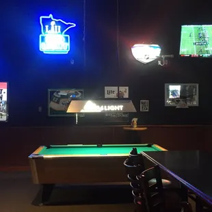 pool table and neon signs
