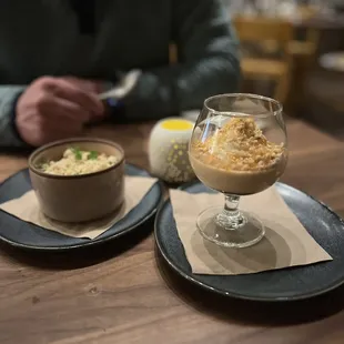 a man sitting at a table with two plates of food