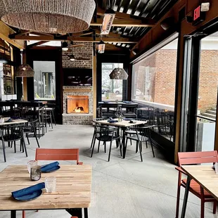 Covered patio with fans, heaters, and a fireplace