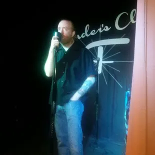 a man singing into a microphone