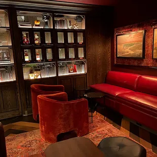 a red leather couch and two red chairs