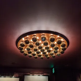 a circular light fixture in a dimly lit room