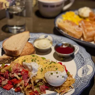 a plate of eggs, hash browns, and toast