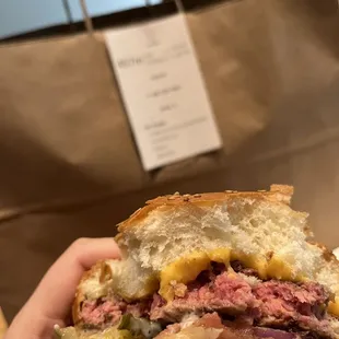A bite into my F&amp;L Burger  It was a tad too red for me
