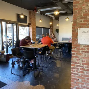a group of people sitting at tables in a restaurant