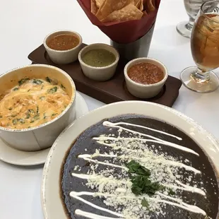 a bowl of soup, a bowl of tortilla, and a bowl of tortilla