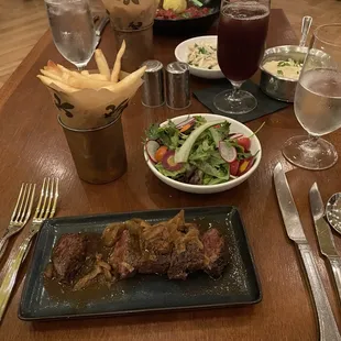 Hanger Steak Frites, side salad and fries.
