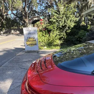 a red sports car parked on the side of the road