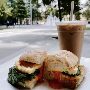 two sandwiches on a plate with a drink