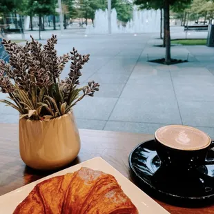 a croissant and a cup of coffee