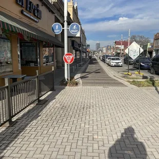 a sidewalk with a stop sign on it