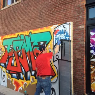 Graffiti artist in action on the plaza!