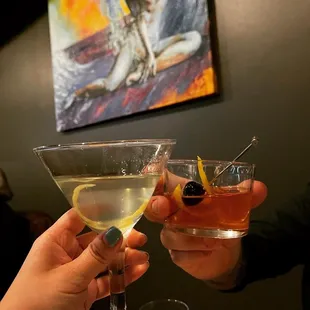 two people toasting drinks