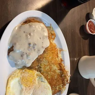 Chicken fried steak over easy eggs hash browns