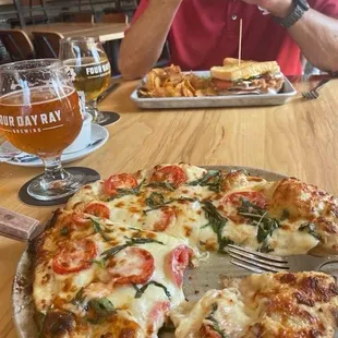 Pizza and club sandwich with homemade chips.