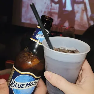two people toasting and drinking beer