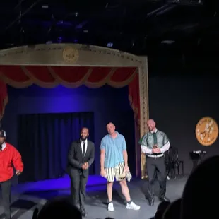 Cast in action, mimicking a coach in audience