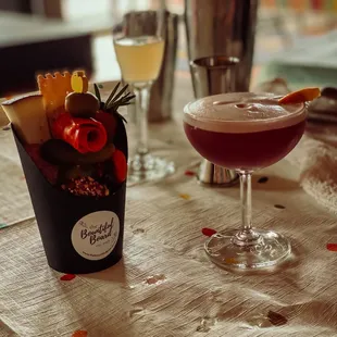 We made a blackberry whiskey sour and had the charcuterie cup to snack on :)  French 75 in background