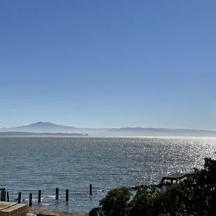 a view of the ocean and mountains