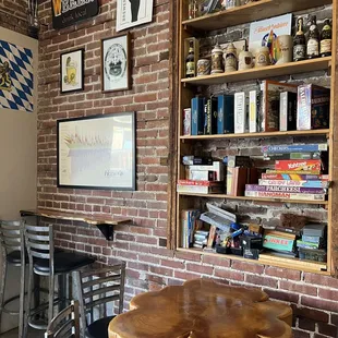 a table and chairs in front of a brick wall