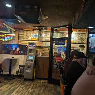 bar area and menu on the wall.