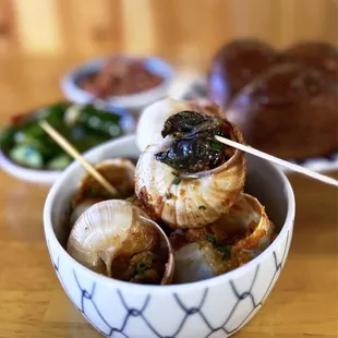 XO Escargot w/ milk bread | 6 pc - $24 (background: complimentary smashed cucumbers + roasted peanuts)
