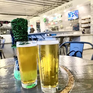 two glasses of beer on a table
