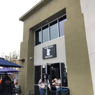 people standing outside of a building