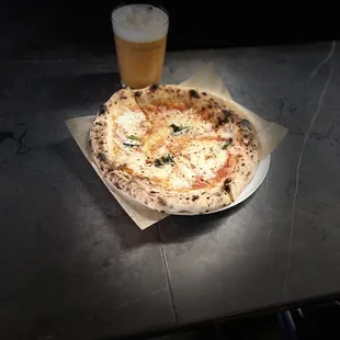 a pizza and a glass of beer