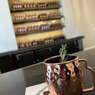 a copper mug with a sprig of rosemary