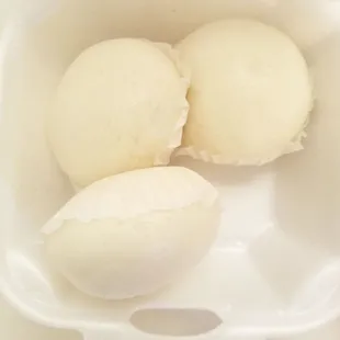 three steamed eggs in a container