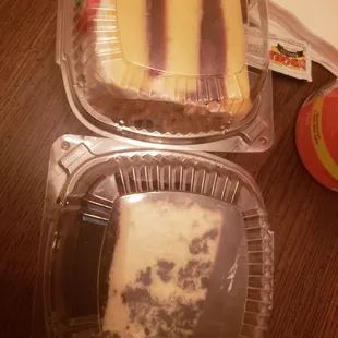 two slices of cake in plastic containers