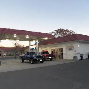 a truck parked in front of a gas station