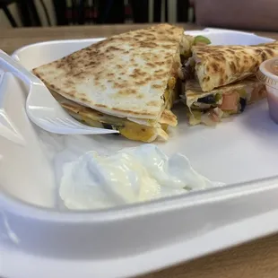 Yummy sour cream and salsa with quesadilla