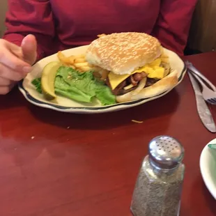 a woman sitting at a table with a plate of food