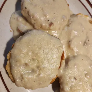 three biscuits covered in gravy