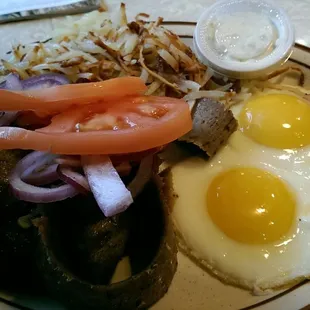 The gyro and eggs with tomatoes and red onions.