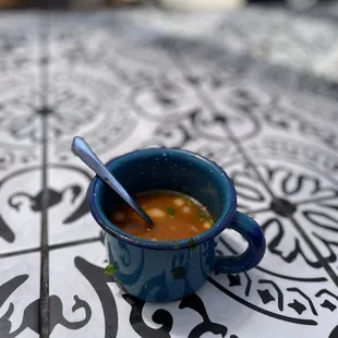 a cup of soup on a table