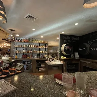 a woman behind a bar counter