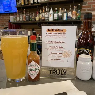 a bar with a menu and a glass of beer