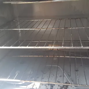 they replaced my stove after over a month of it not working only to replace it with this filthy one! (pic 1 of stove)