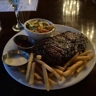 Steak, fries and sautéed vegetables (zucchini, bell peppers, cabbage).