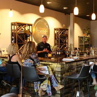 a group of people sitting at a bar